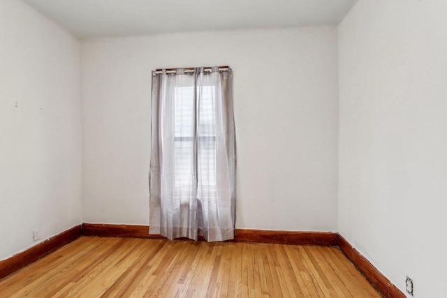 spare room with wood-type flooring