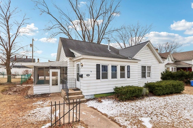 view of snow covered exterior with a sunroom