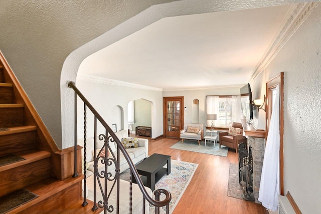 interior space featuring wood-type flooring and crown molding