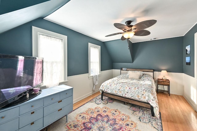 bedroom with vaulted ceiling, light wood-type flooring, and ceiling fan