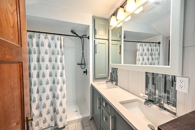 bathroom with walk in shower, vanity, and tasteful backsplash