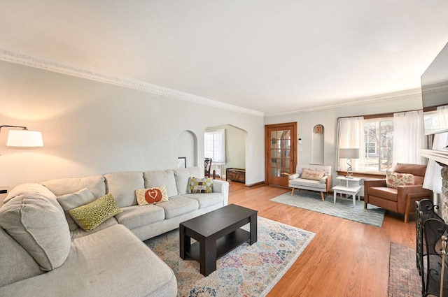 living room featuring ornamental molding and light hardwood / wood-style floors