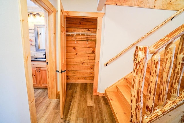 hallway featuring hardwood / wood-style flooring and sink