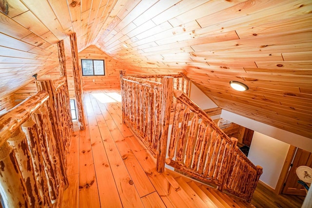 bonus room with wooden walls, light hardwood / wood-style floors, wooden ceiling, and vaulted ceiling