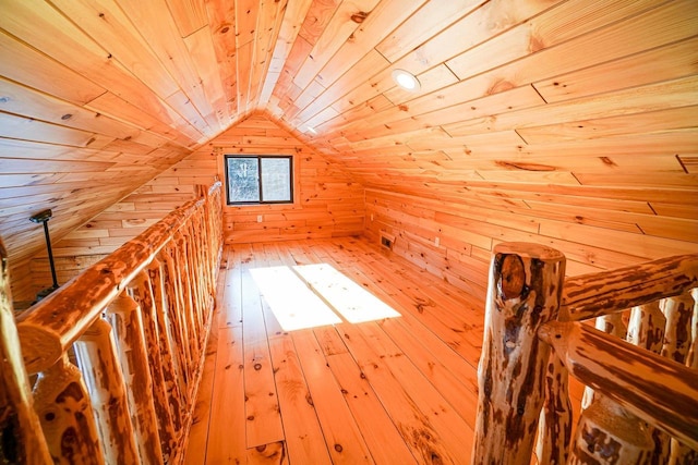 additional living space with wood ceiling, wooden walls, and lofted ceiling