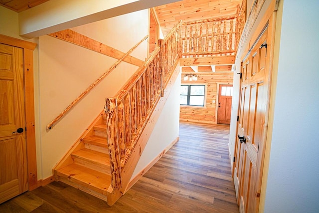 stairs with wooden walls and wood-type flooring