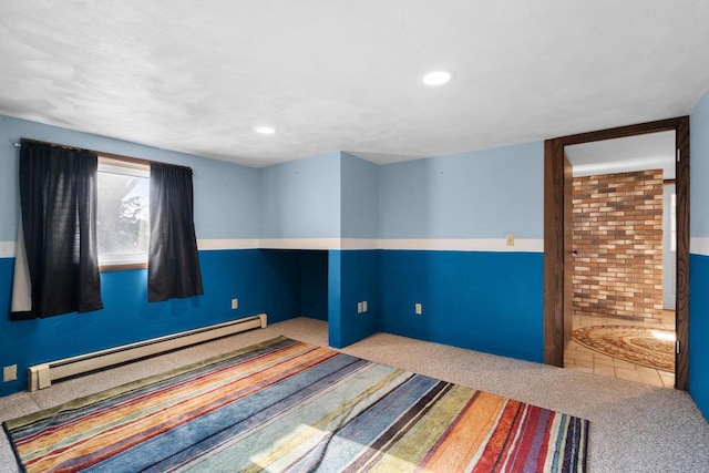 carpeted bedroom featuring baseboard heating