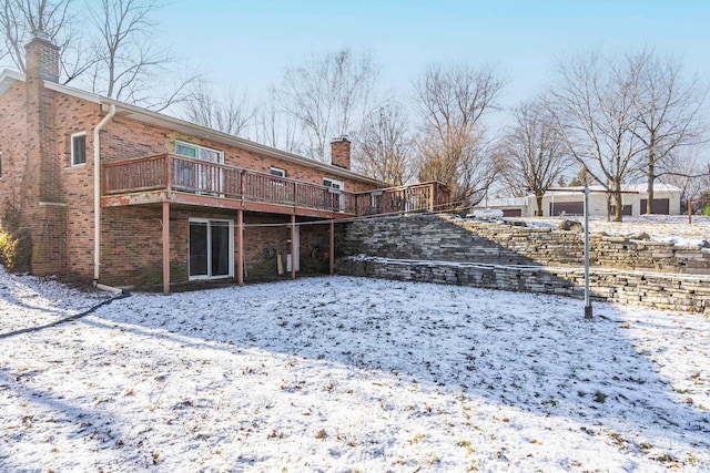 snow covered house with a deck