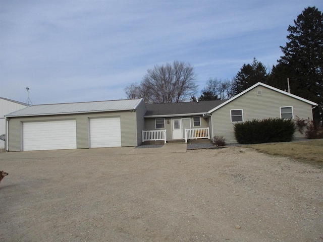 single story home with a garage and a porch