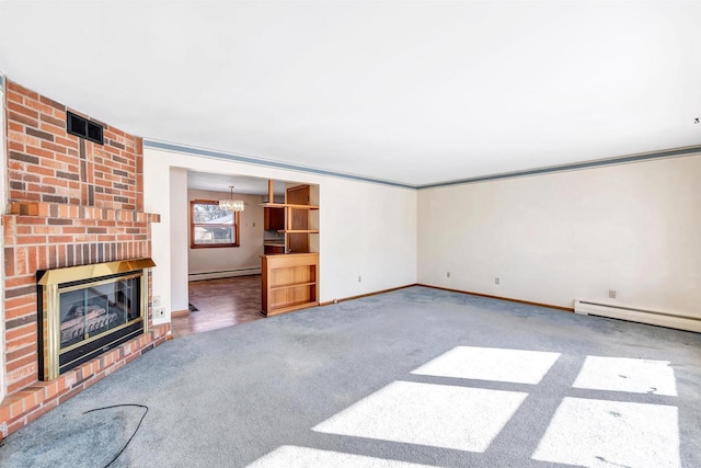 unfurnished living room featuring a chandelier, carpet flooring, a fireplace, and a baseboard heating unit