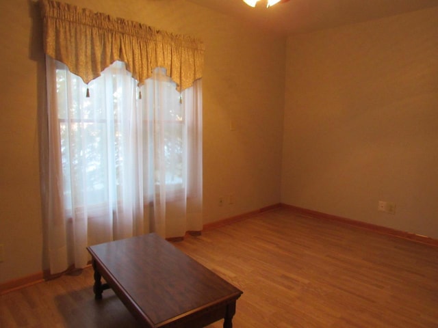 home office with baseboards and light wood-style floors