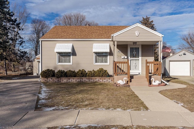 view of front of property with an outbuilding, a front yard, and a garage