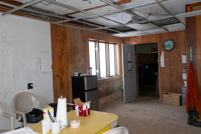 dining space with wood walls