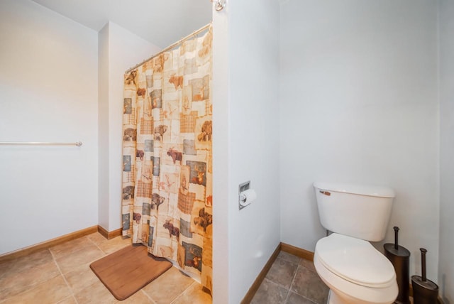 bathroom with a shower with shower curtain and toilet