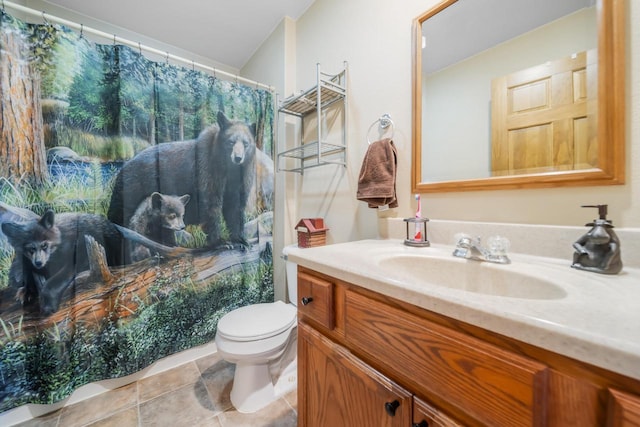 bathroom featuring tile patterned floors, vanity, and toilet