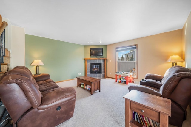 carpeted living room featuring a tile fireplace