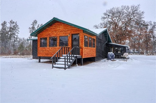 view of snow covered rear of property