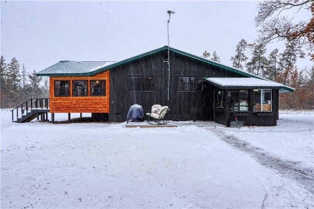 view of snow covered back of property