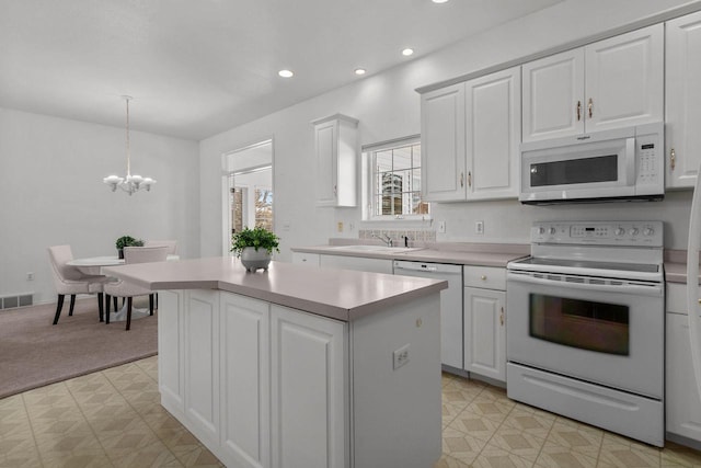 kitchen with white cabinetry, a center island, white appliances, light carpet, and pendant lighting