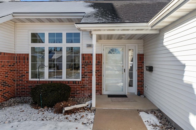 view of snow covered property entrance