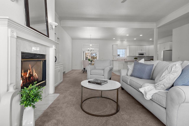 carpeted living room with a tile fireplace