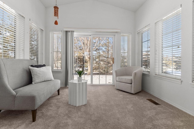 living area featuring lofted ceiling and light carpet