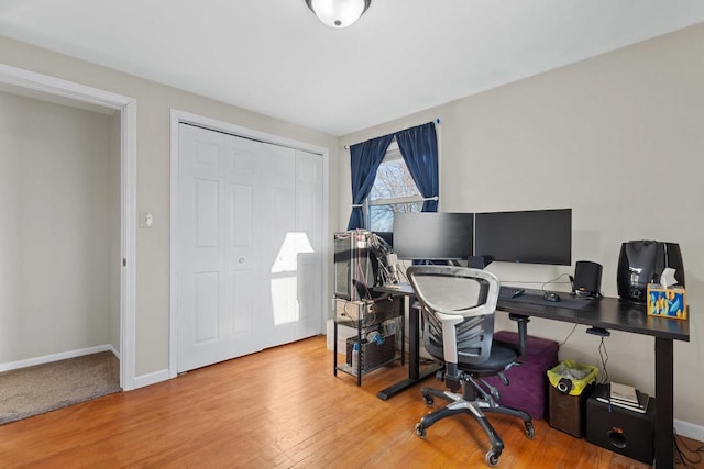 home office with hardwood / wood-style flooring