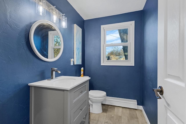 bathroom featuring toilet, a baseboard radiator, vanity, and wood-type flooring