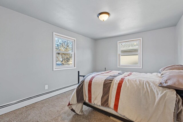 carpeted bedroom with a baseboard radiator