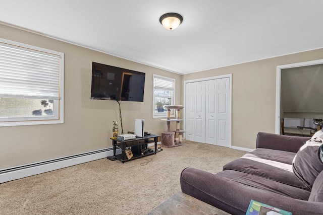 carpeted living room featuring a baseboard heating unit