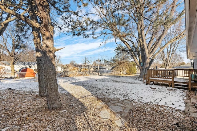 yard covered in snow featuring a wooden deck