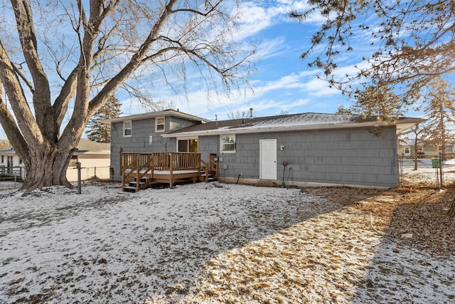 snow covered property with a wooden deck