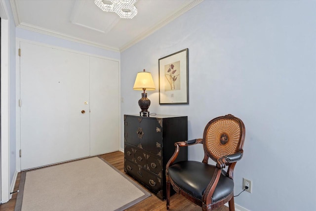 living area featuring hardwood / wood-style flooring and crown molding