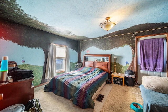 bedroom featuring a textured ceiling and carpet floors