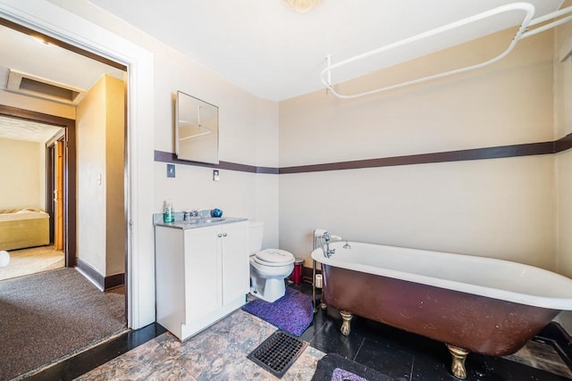 bathroom with toilet, vanity, and a bathing tub