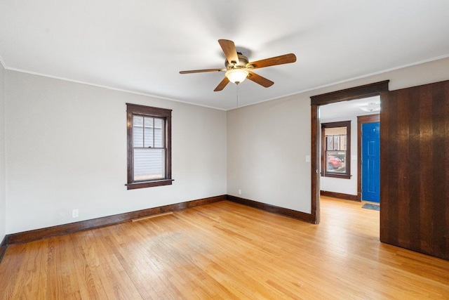 empty room featuring crown molding, ceiling fan, and light hardwood / wood-style flooring