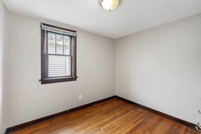 spare room with wood-type flooring