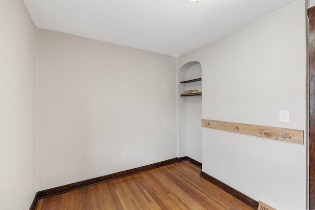 unfurnished room with hardwood / wood-style flooring