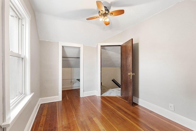 unfurnished bedroom with ceiling fan, hardwood / wood-style floors, vaulted ceiling, and a closet