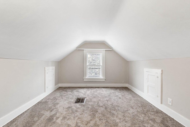 bonus room featuring vaulted ceiling and carpet flooring