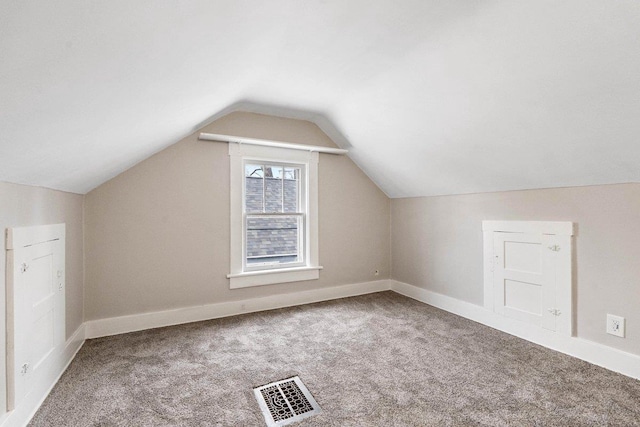 bonus room featuring lofted ceiling and carpet floors