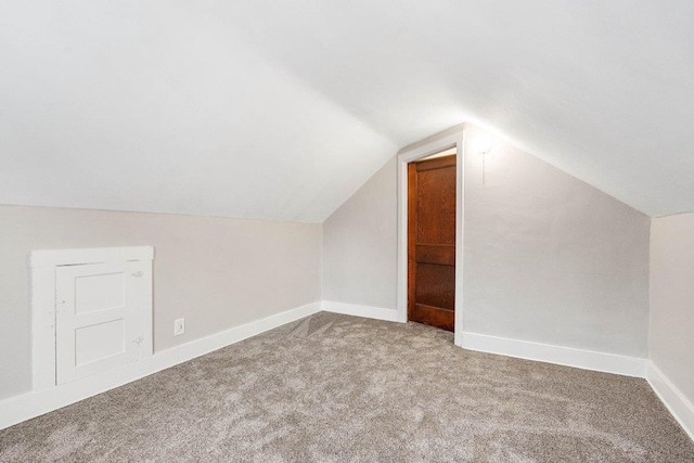 bonus room featuring lofted ceiling and carpet floors