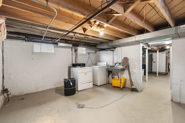 basement with separate washer and dryer and sink