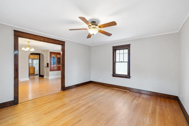 unfurnished room with ceiling fan with notable chandelier, ornamental molding, and hardwood / wood-style flooring