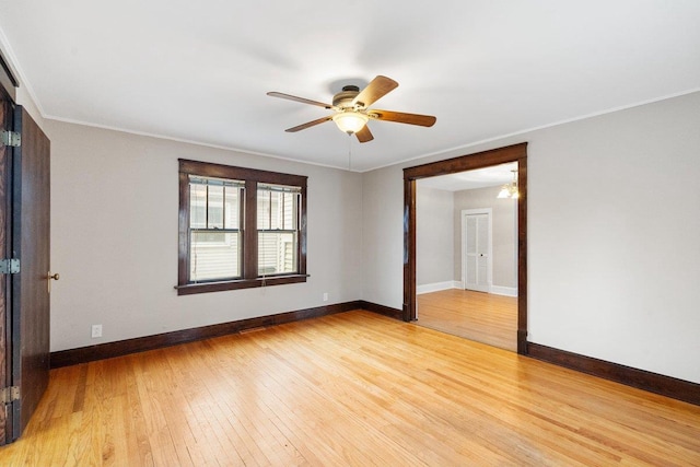 unfurnished room featuring ornamental molding, light hardwood / wood-style flooring, and ceiling fan with notable chandelier