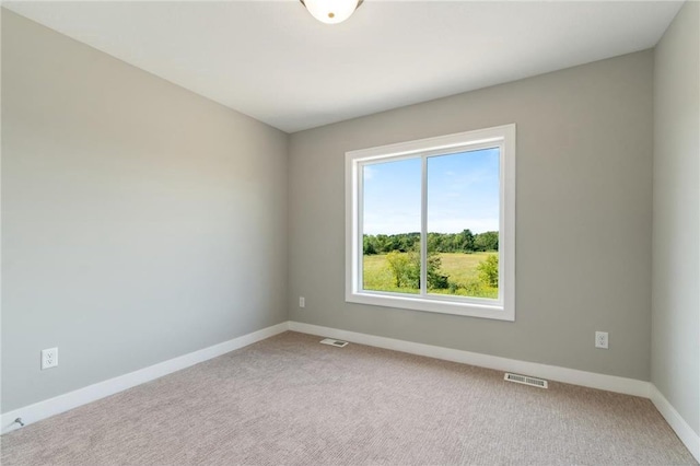 unfurnished room featuring carpet