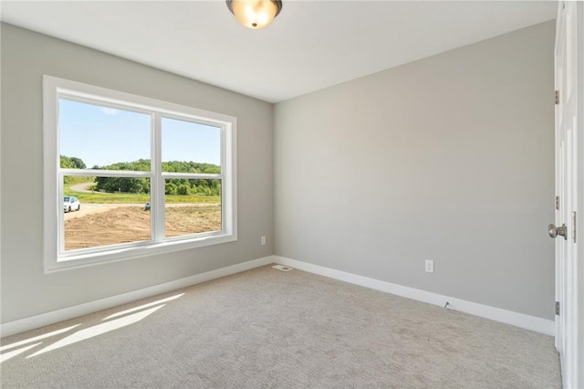 empty room featuring light colored carpet