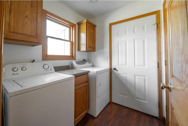 washroom featuring dark hardwood / wood-style floors, cabinets, and independent washer and dryer