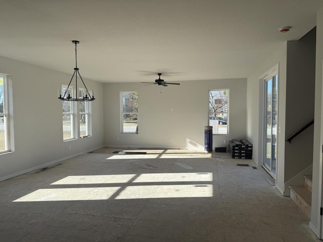 interior space with ceiling fan with notable chandelier