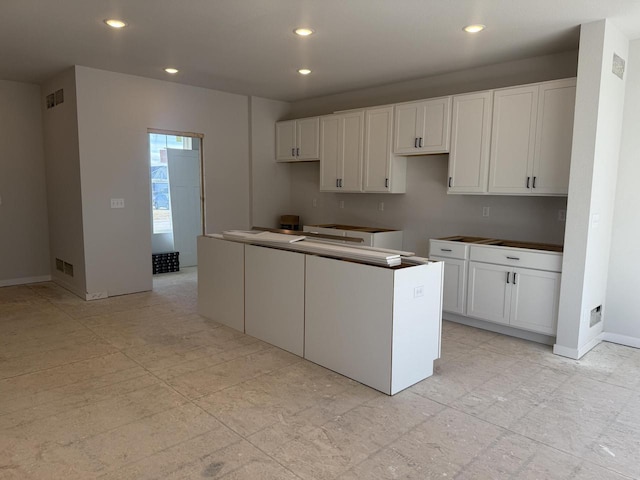 kitchen with white cabinetry and a center island